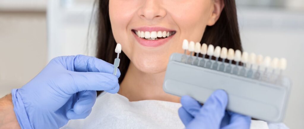 dentist applying sample from tooth scale to happy patient