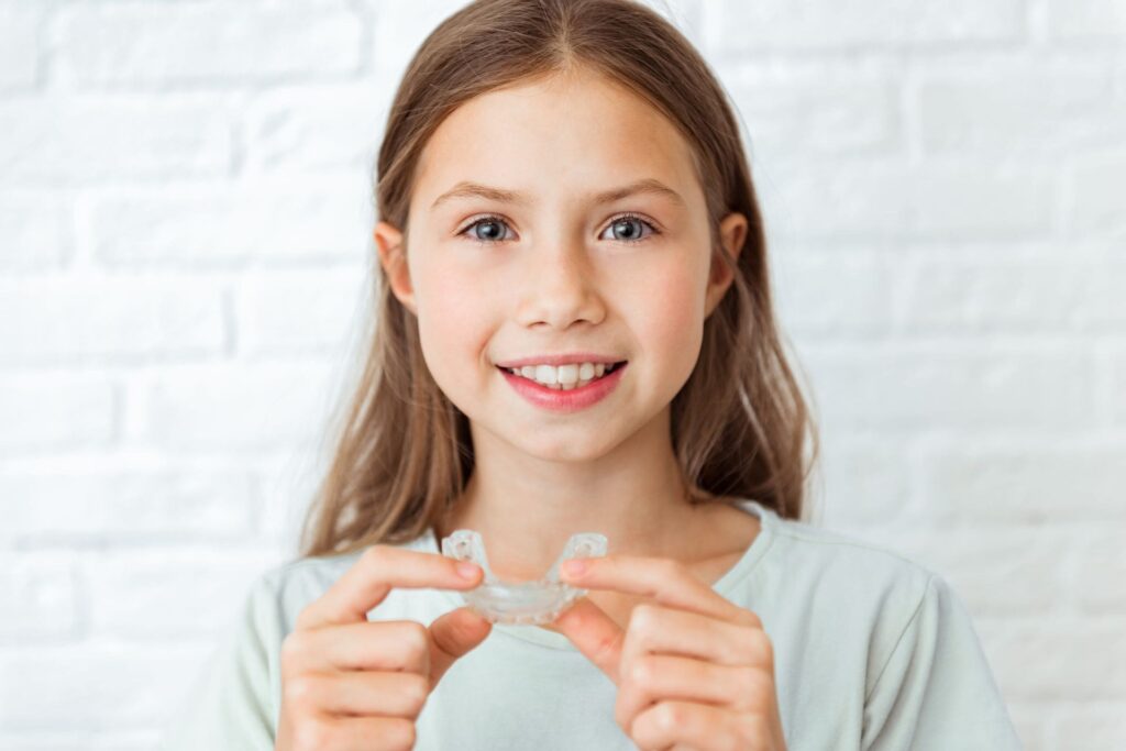 smiling child girl with perfect and healthy teeth